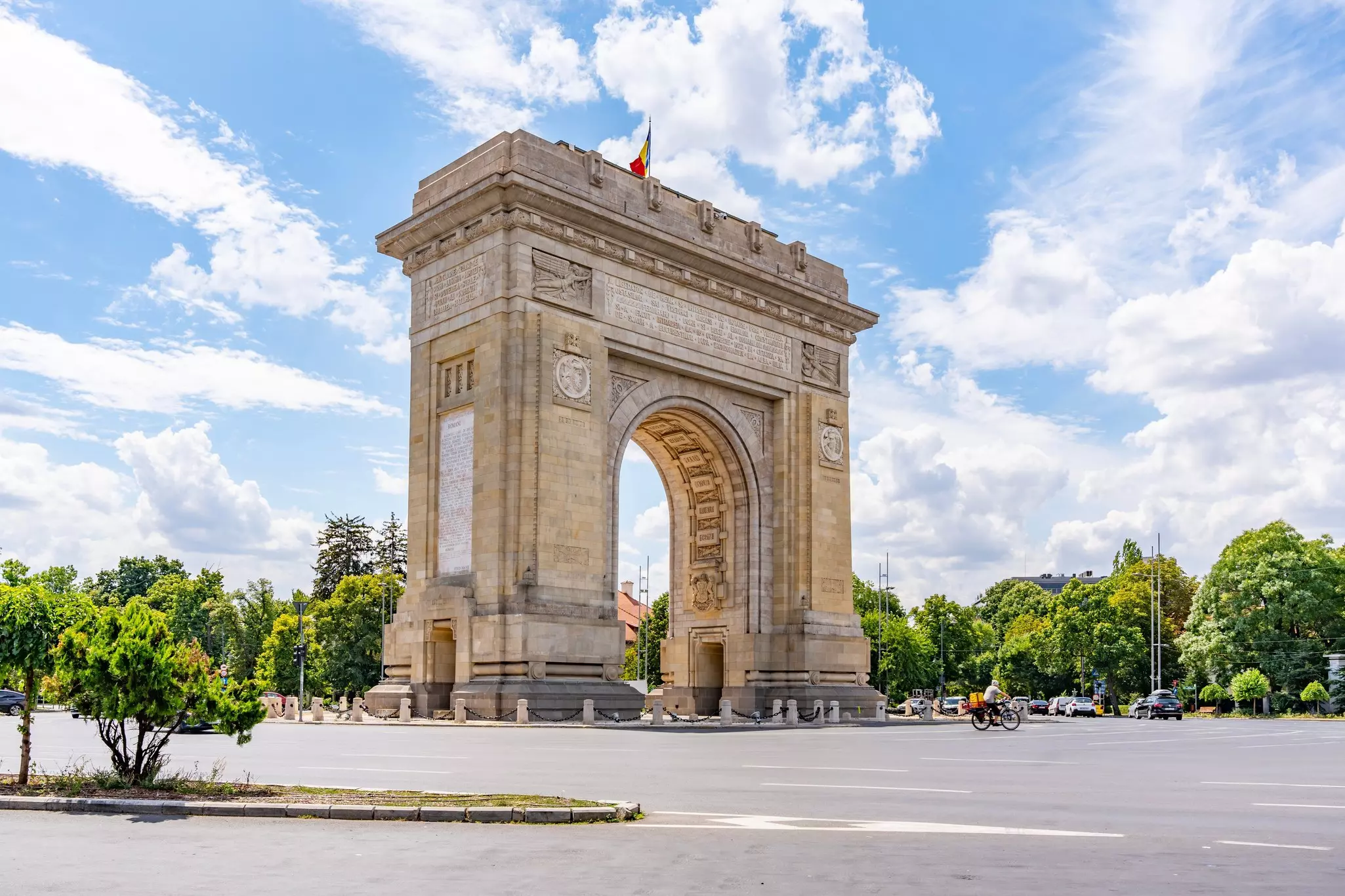 Arch of Triumph ( Arcul de Triumf) in Bucharest the Romania capital a historical monument, day time shot with sunny blue sky