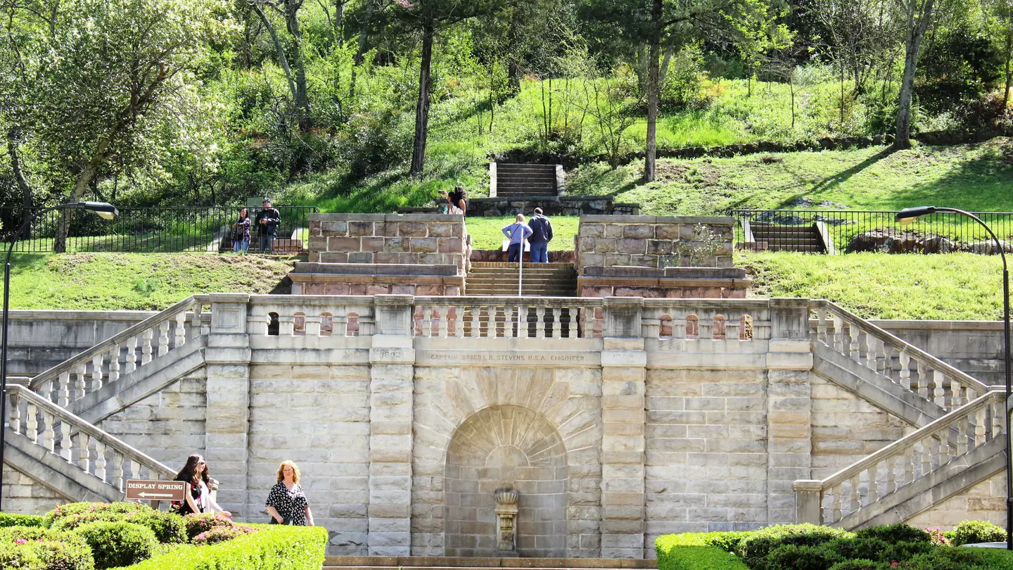 Tourists visit the formal entrance and balustrade to Hot Springs National Park, constructed in 1892, overseen by Captain Robert R Stevens, a West Point graduate