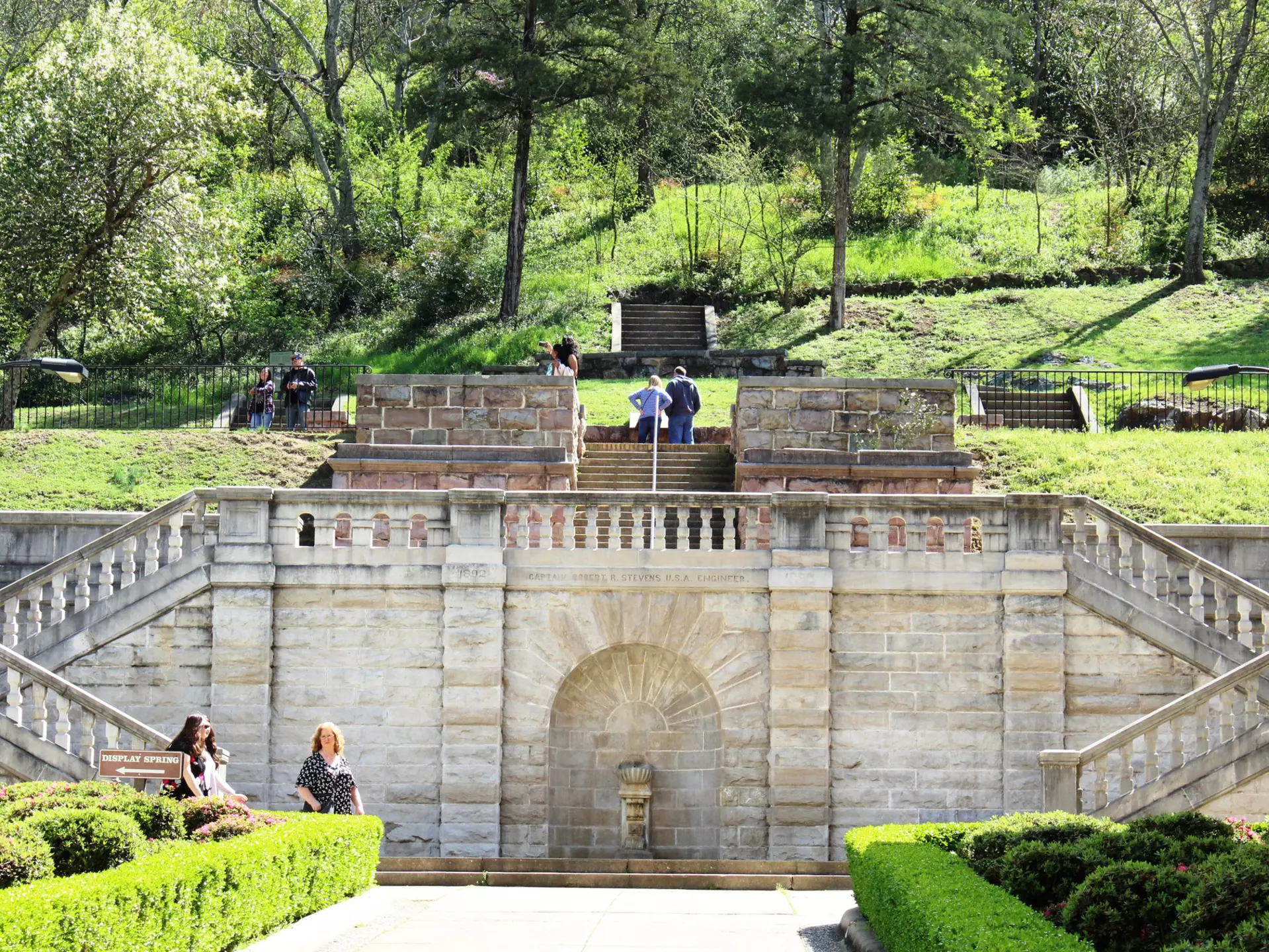Tourists visit the formal entrance and balustrade to Hot Springs National Park, constructed in 1892, overseen by Captain Robert R Stevens, a West Point graduate