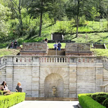 Tourists visit the formal entrance and balustrade to Hot Springs National Park, constructed in 1892, overseen by Captain Robert R Stevens, a West Point graduate