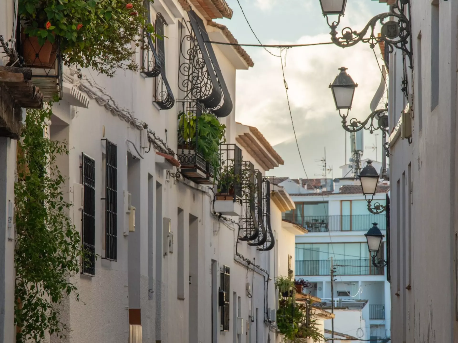 View of the narrow cobblestone street with whitewashed houses in an old town part of Altea resort town on Costa Blanca, Spain, License Type: media, Download Time: 2025-02-24T16:04:26.000Z, User: Ppeterson948, Editorial: false, purchase_order: 56530 - Guidebooks, job: Global Publishing WIP, client: Global Publishing WIP, other: Pia Peterson Haggarty