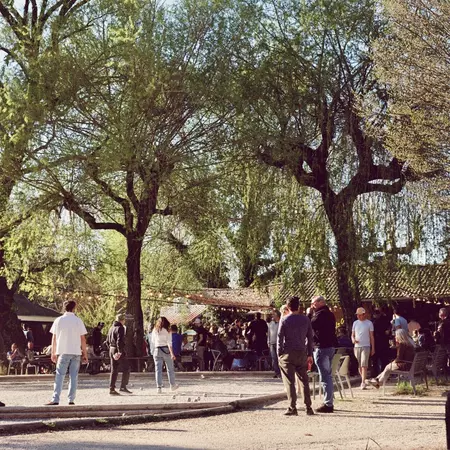 People playing pétanque outside a bar 
