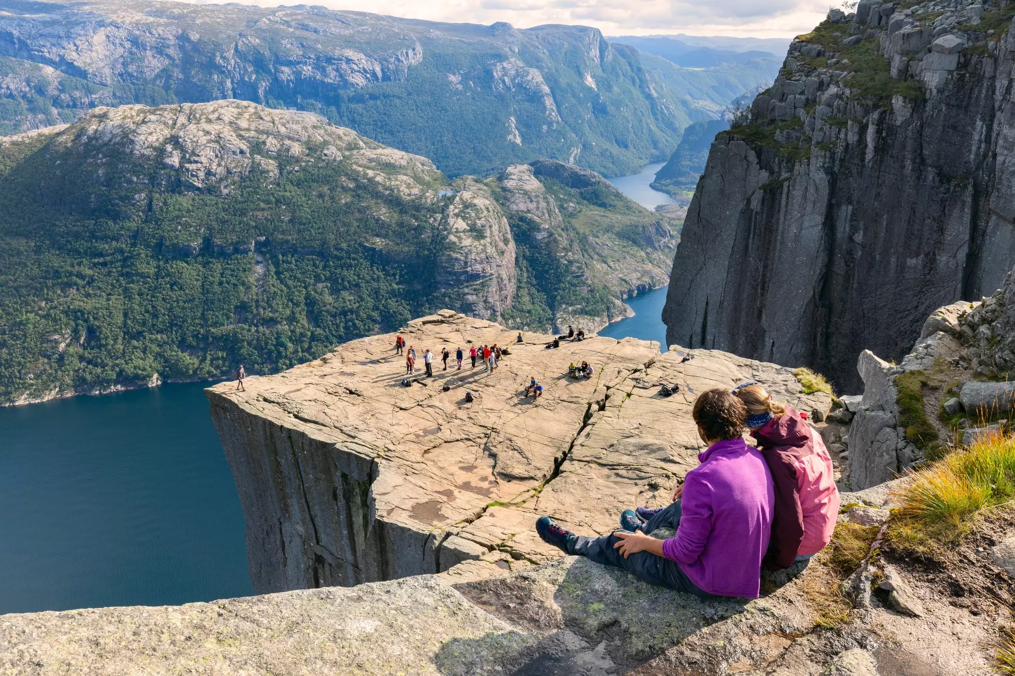 Hikers admiring the view at Preikestolen near Stavanger, Norway.
