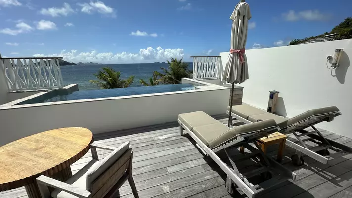 Private pool next to a deck with chaises