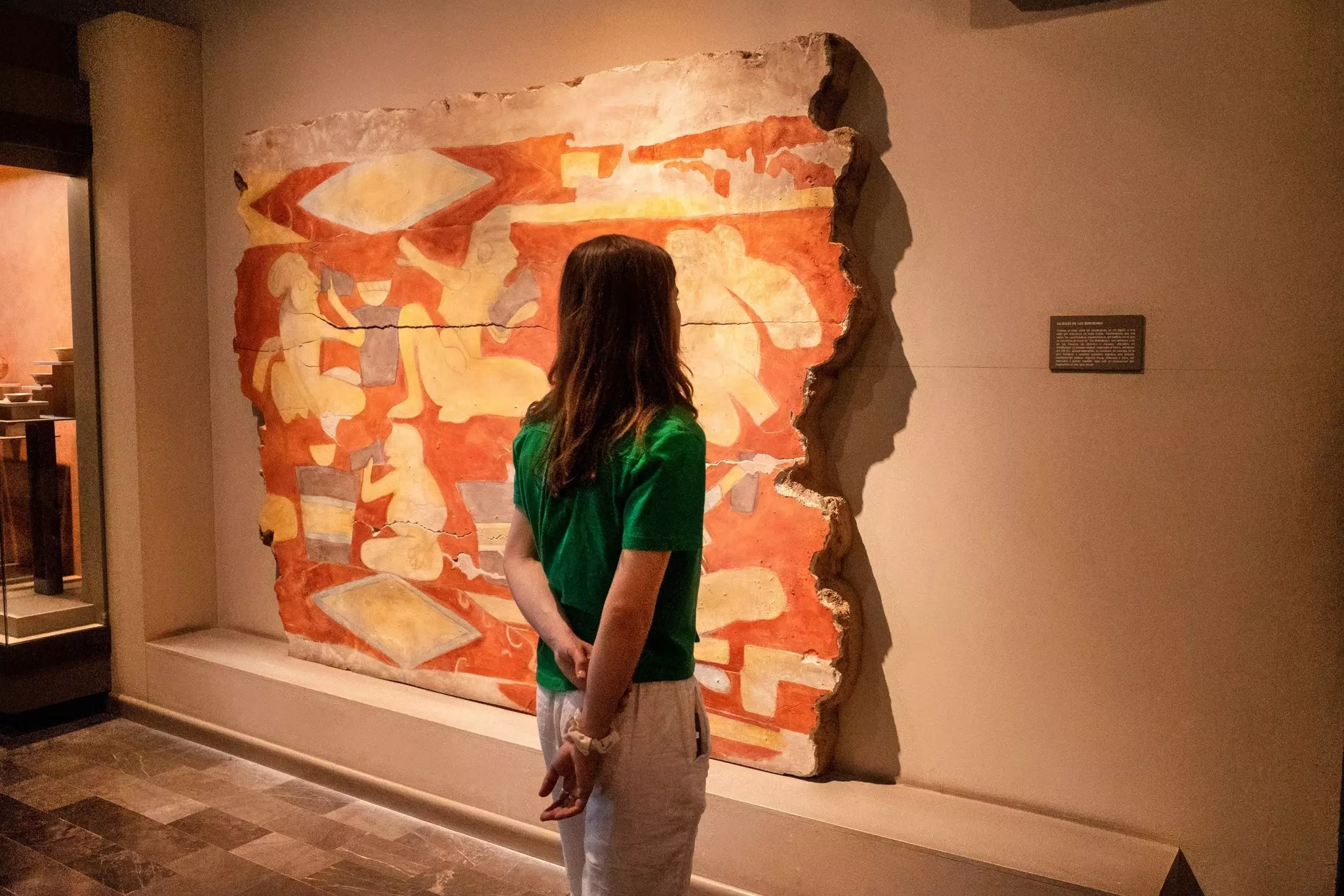 A woman looks at an artwork in Mexico City's Museum of Anthropology.