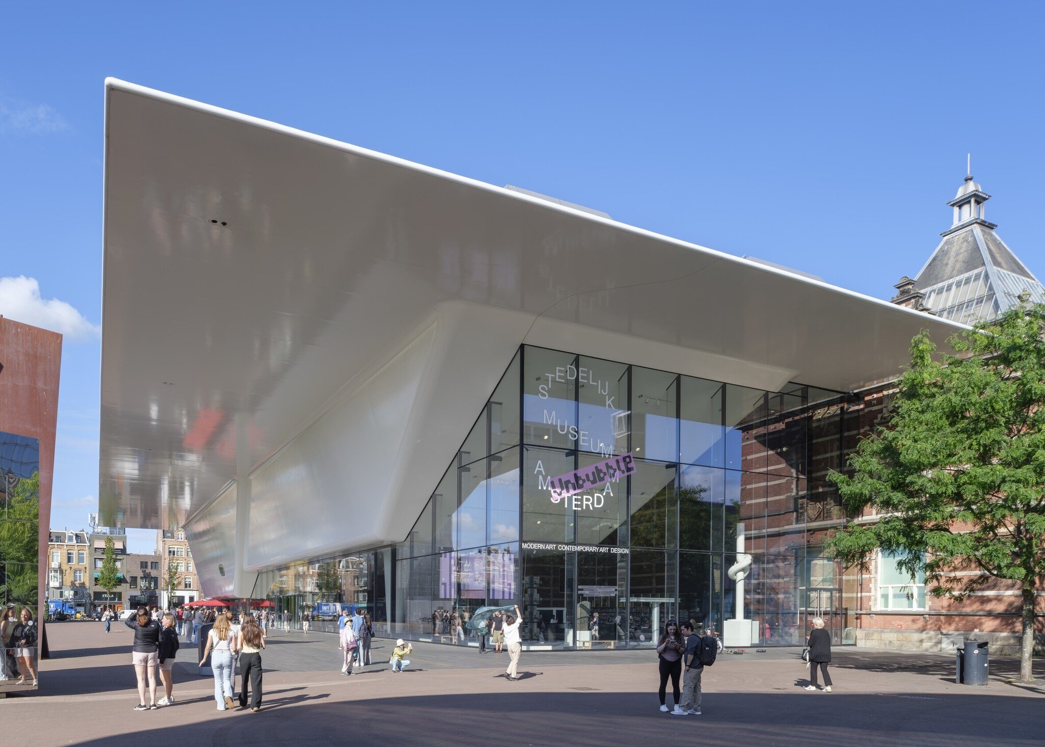 Exterior view of the Stedelijk Museum on a sunny day in Amsterdam.