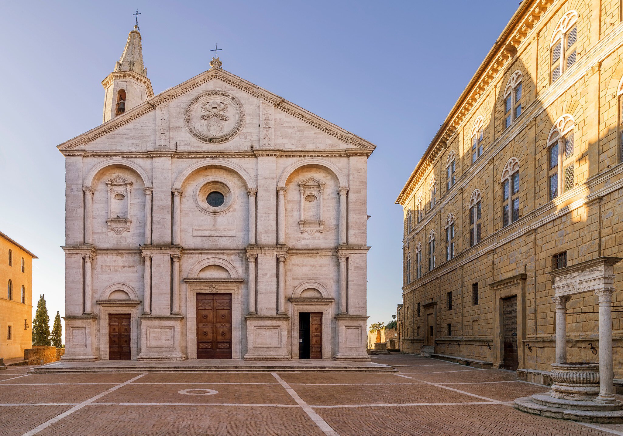 Pio II square and the Duomo of Pienza without people in the morning light.