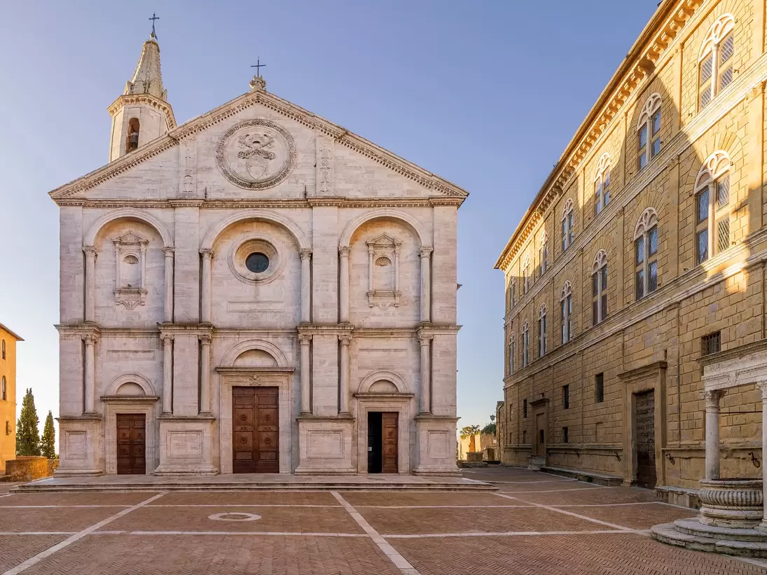 Pio II square and the Duomo of Pienza without people in the morning light.