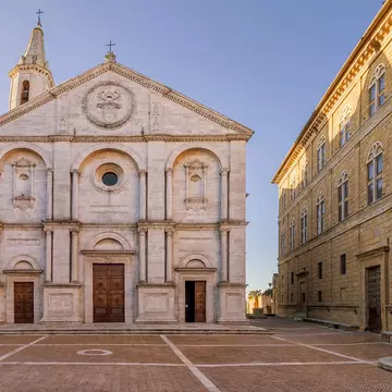 Pio II square and the Duomo of Pienza without people in the morning light.