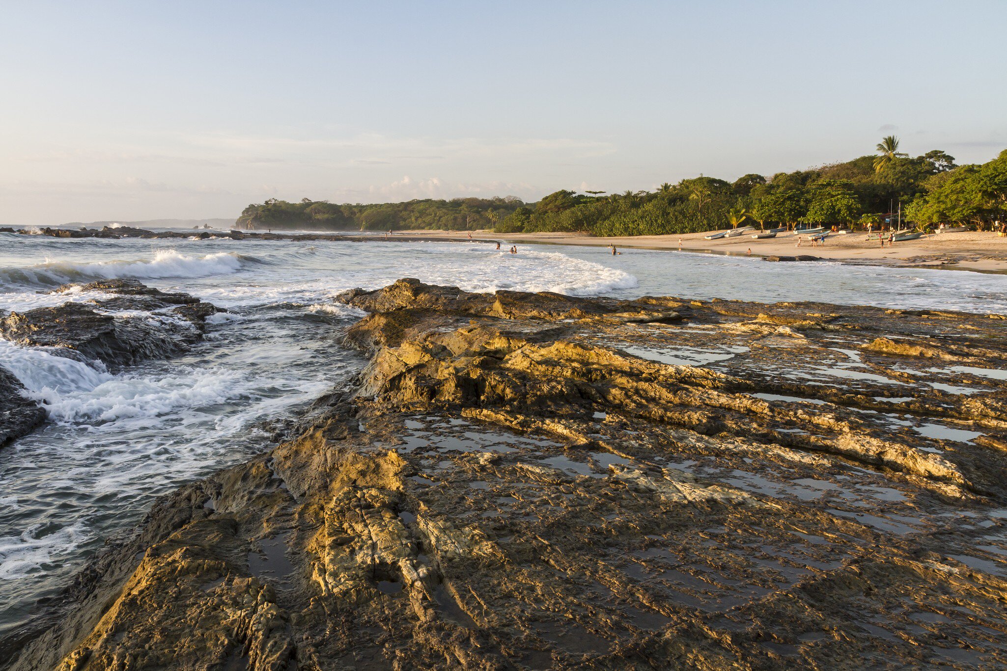 Waves crash on the rocky shore on Playa Pelada on the Pacific Coast of Costa Rica.