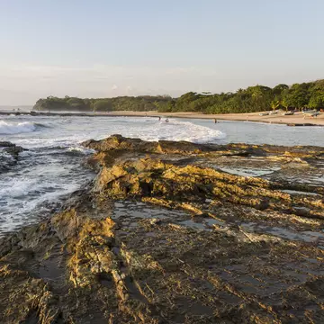 Waves crash on the rocky shore on Playa Pelada on the Pacific Coast of Costa Rica.
