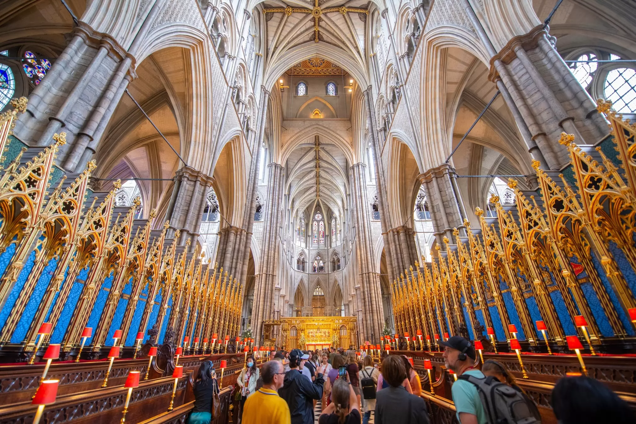 Visitors fill the gilded quire of Westminster Abbey beneath its soaring vaulted ceiling
