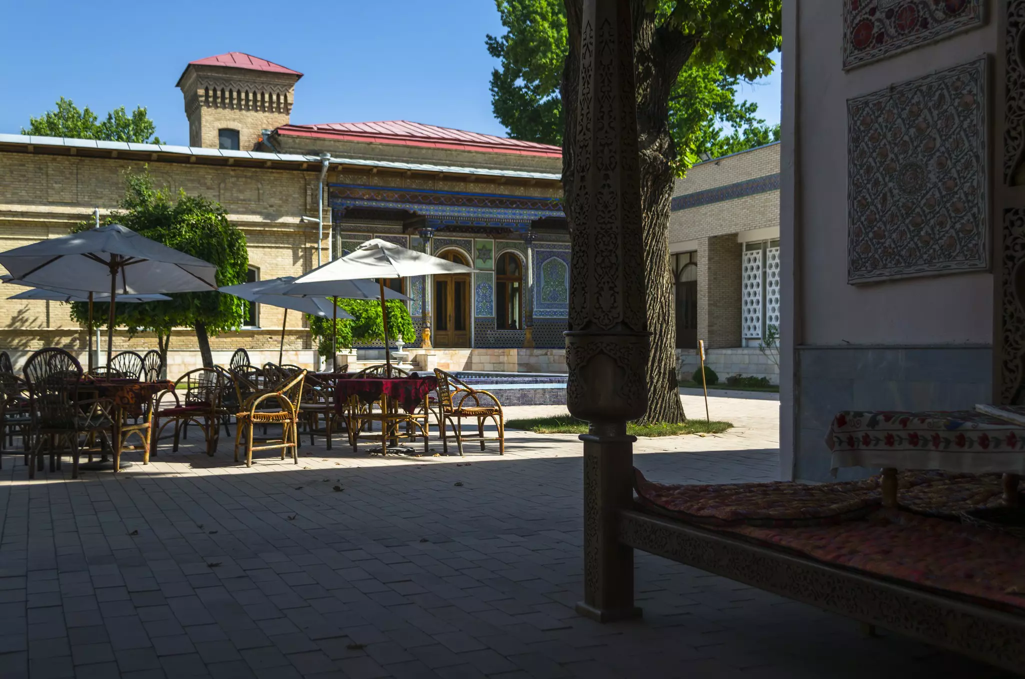 Outside the Museum of Applied Arts with umbrella-shaded tables and chairs