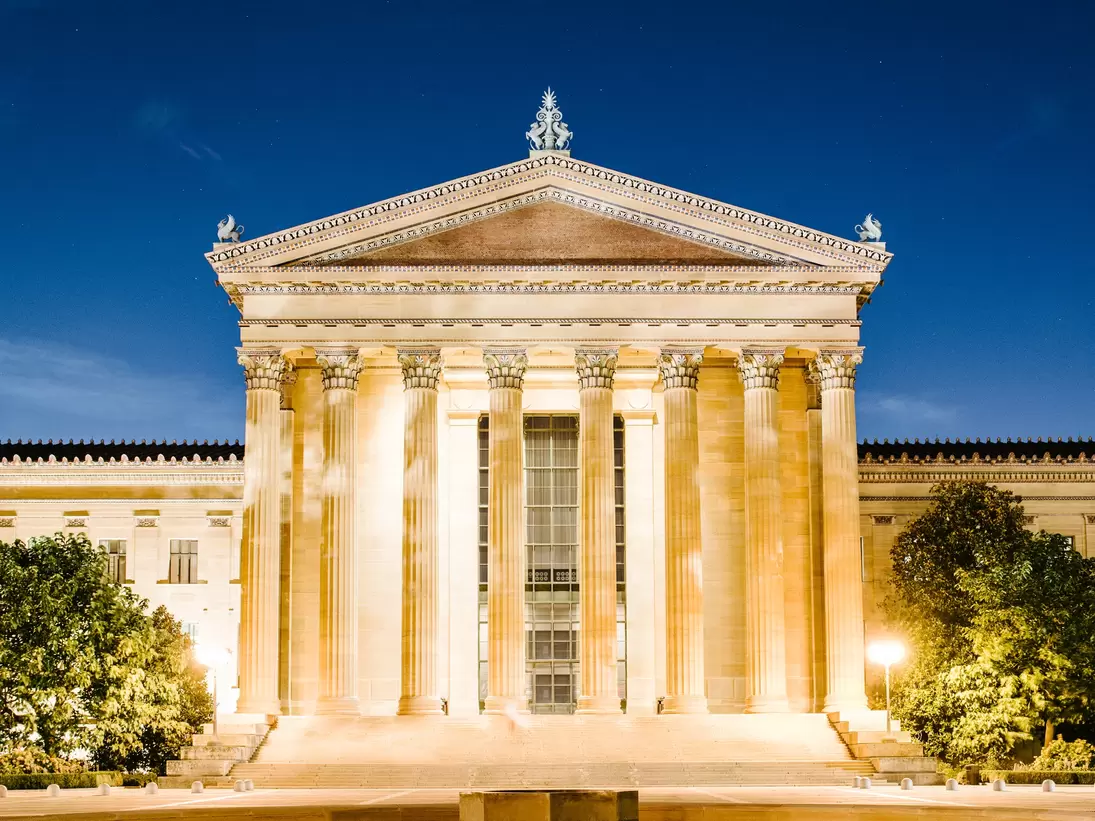 Exterior of the Philadelphia Art Museum entrance at night.