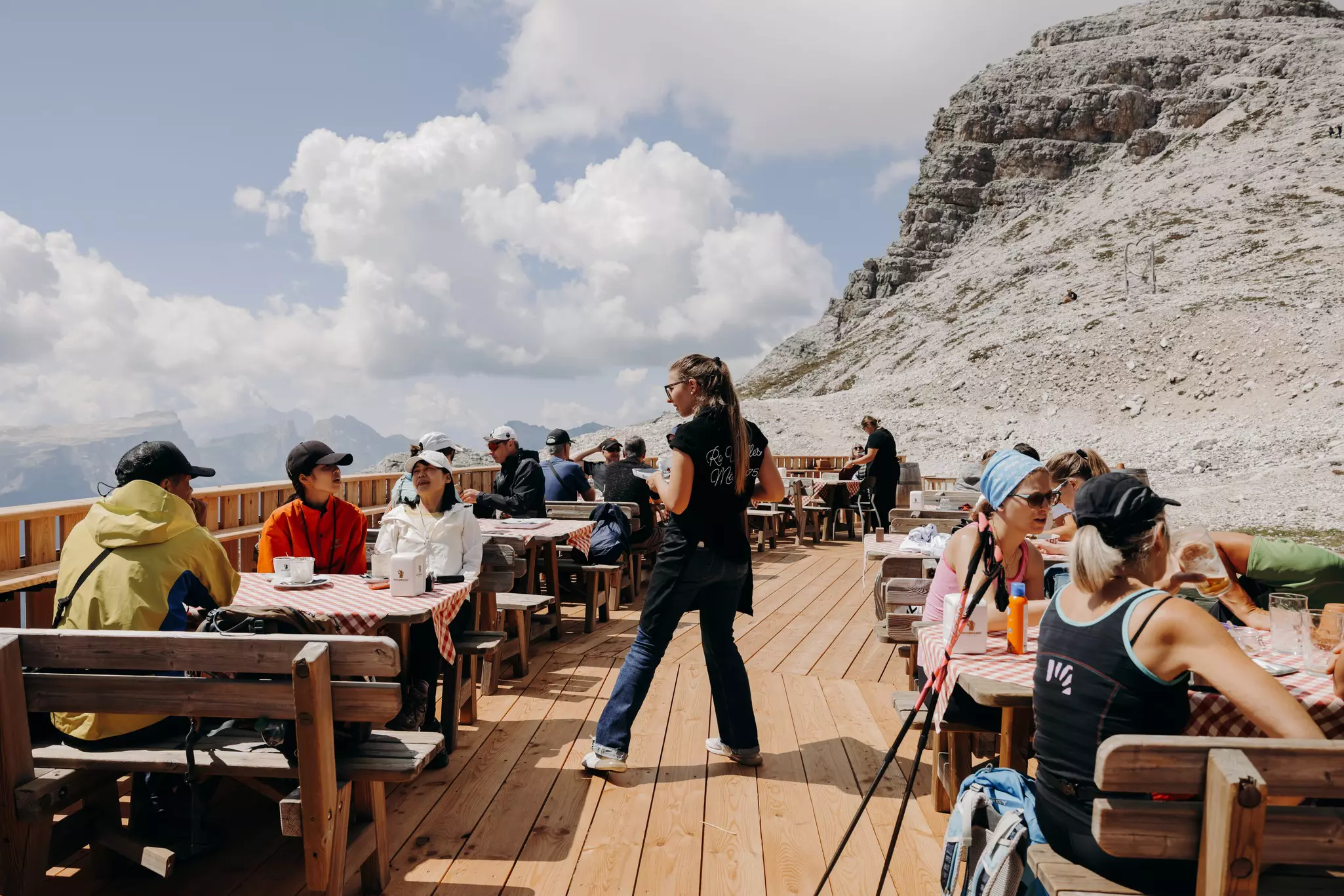 Waitress serving tables of people at a restaurant in the mountains.