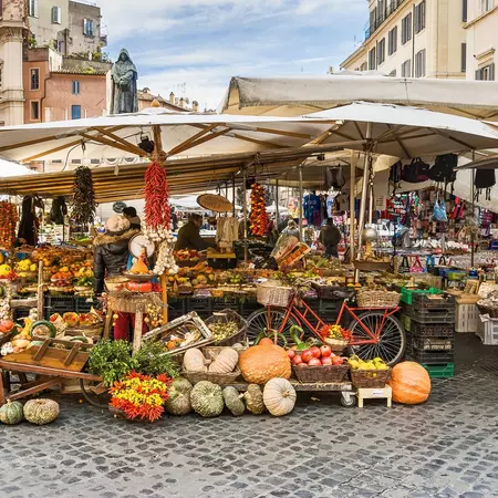 Winter vegetables like pumpkins and apples line the foodstalls in a Roman Market. 