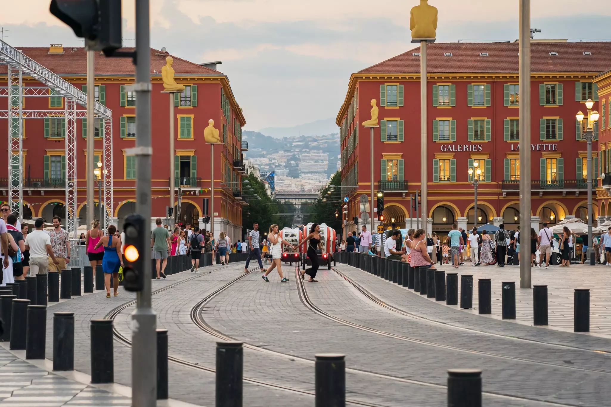 Tram lines at Place Massena near Galeries Lafayette at dusk in Nice, France