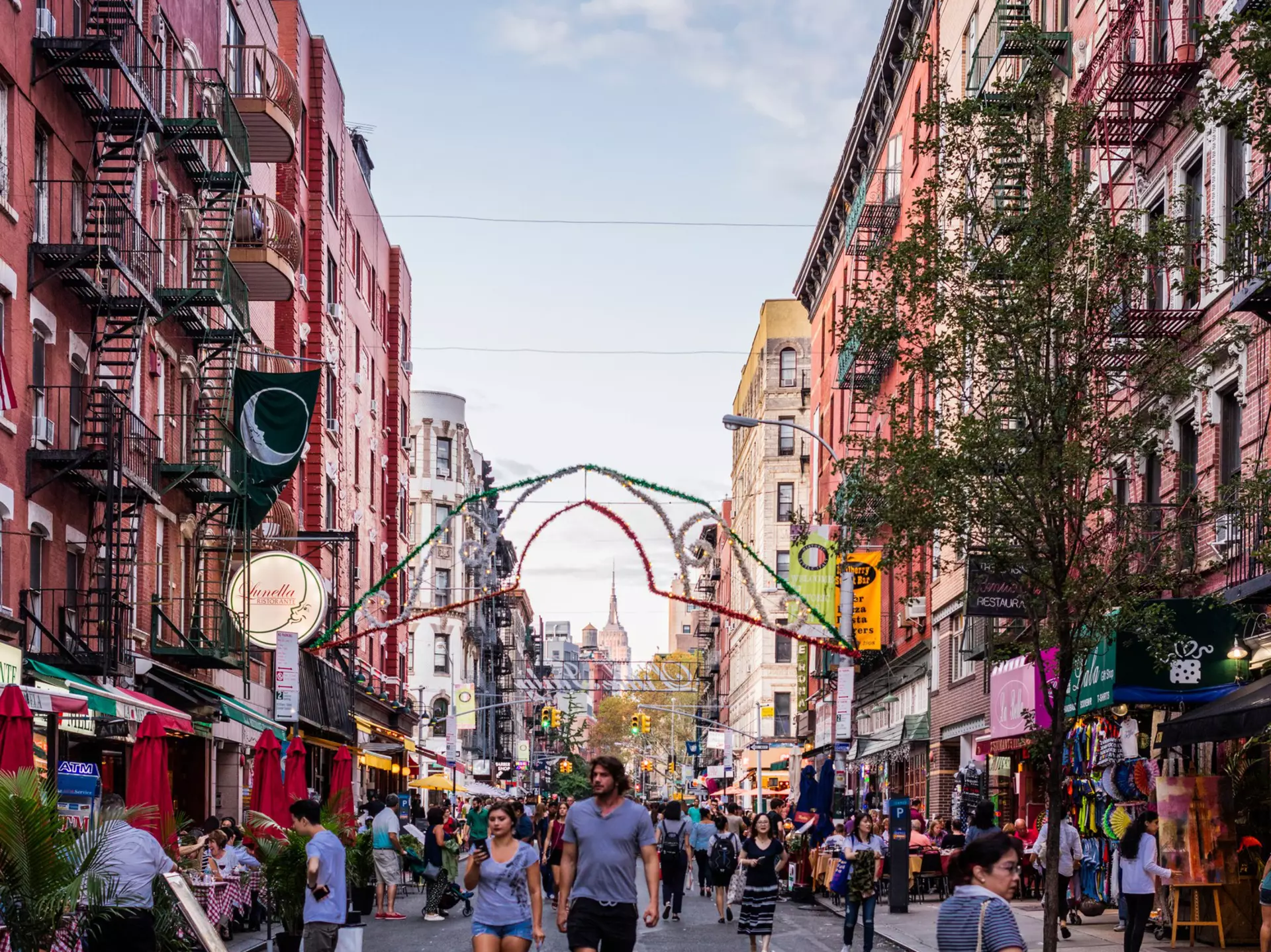 New York City, United States - August 26, 2017: Mulberry Street, Manhattan, with people, and Empire State Building in the background., License Type: media, Download Time: 2025-11-26T20:16:04.000Z, User: LP_YKhanna, Editorial: true, purchase_order: 65050 - Digital Destinations and Articles, job: LP, client: App Content, other: Yuvraj Khanna