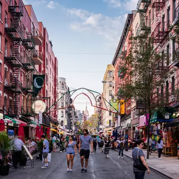 New York City, United States - August 26, 2017: Mulberry Street, Manhattan, with people, and Empire State Building in the background., License Type: media, Download Time: 2025-11-26T20:16:04.000Z, User: LP_YKhanna, Editorial: true, purchase_order: 65050 - Digital Destinations and Articles, job: LP, client: App Content, other: Yuvraj Khanna