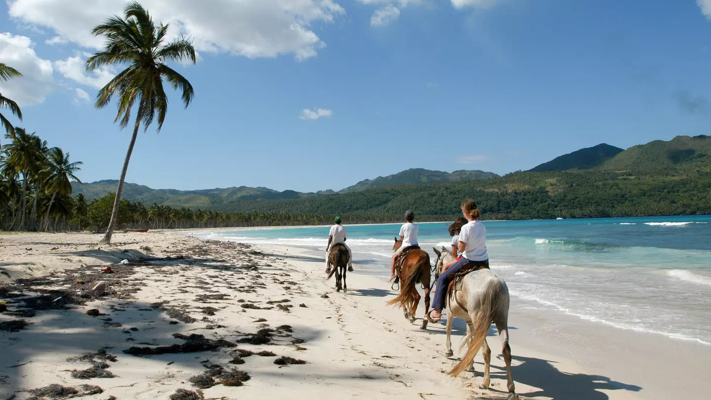 People riding horses on the beach of Rincon near Las Galeras on Dominican Republic.