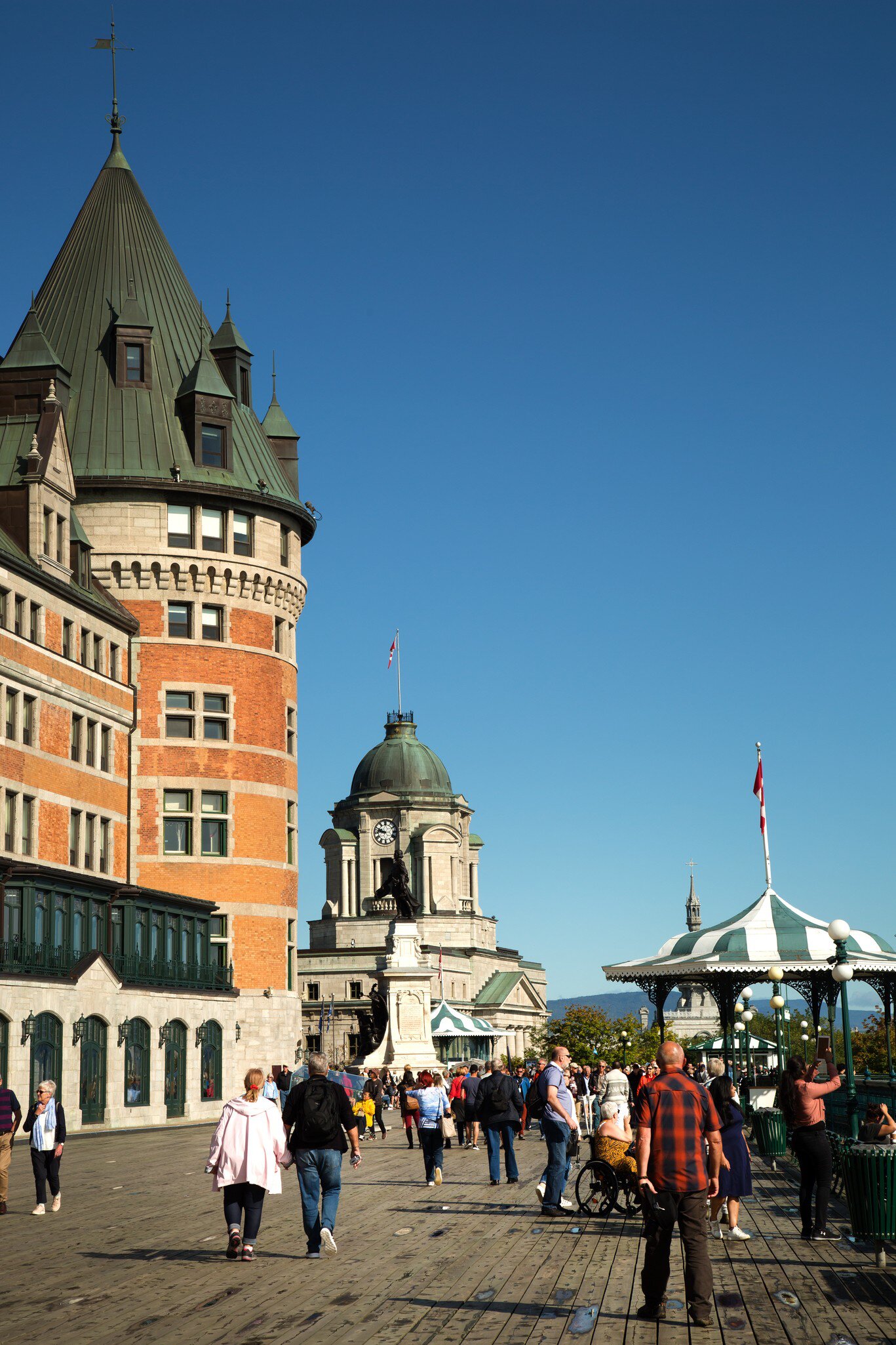 QUEBEC-CANADA, SEPT 12, 2019:  People walking on Terrasse Dufferin close the Chateau Frontenac, an historic hotel in Quebec City, Quebec, Canada, one of the most photographed in the world.  License Type: media  Download Time: 2022-02-17T15:25:53.000Z  User: gwencotter  Is Editorial: Yes  purchase_order:   