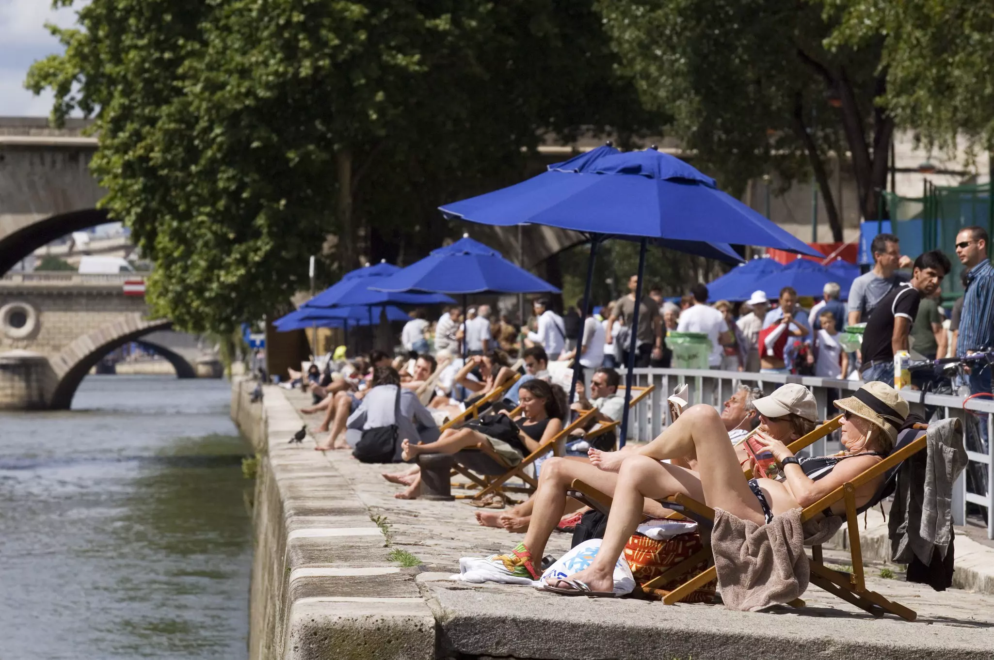 Sunbathers on banks of River Seine at the Paris Plage (Paris beach). 
