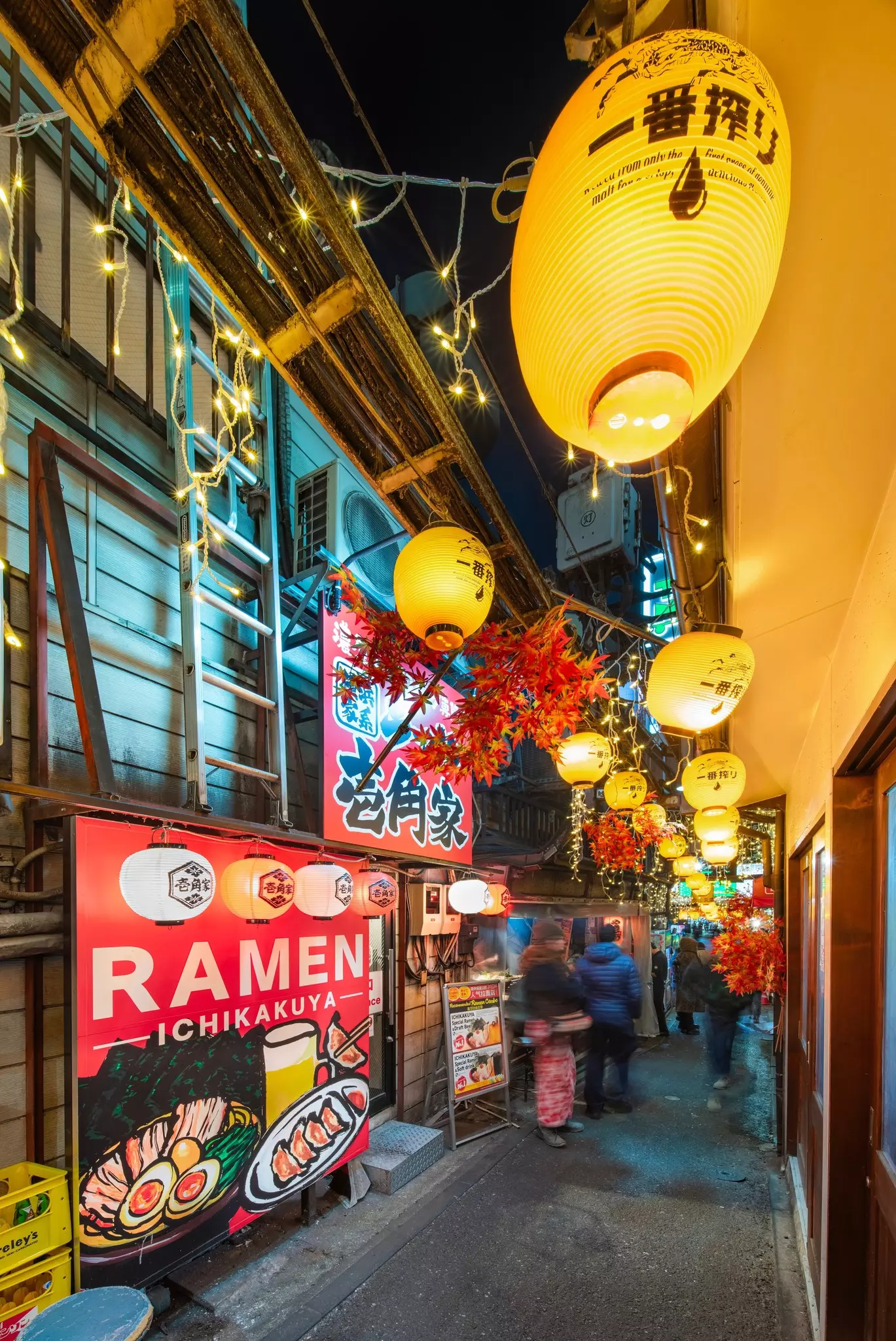 tokyo, shinjuku - jan 13 2025: Japanese lanterns illuminate a narrow alley of Omoide Yokocho, a spot featuring traditional ramen shops and nostalgic cultural elements reflecting Japan's retro charm.