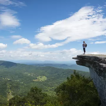 Hikers take in the view of the Appalachian Mountains from McAfee Knob on Catawba Mountain.