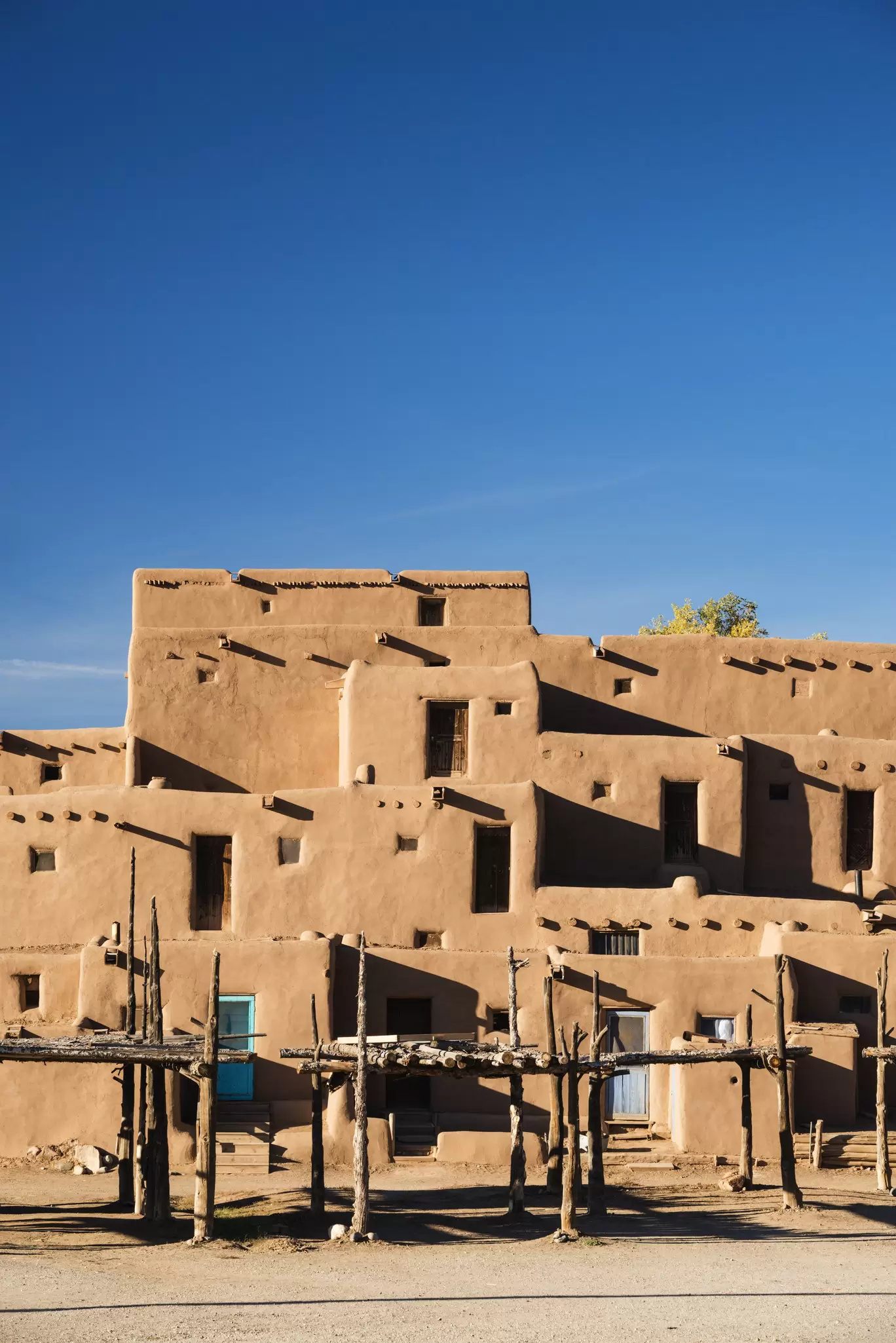 Rectangular buildings made of adobe in the desert at Taos Pueblo, New Mexico.