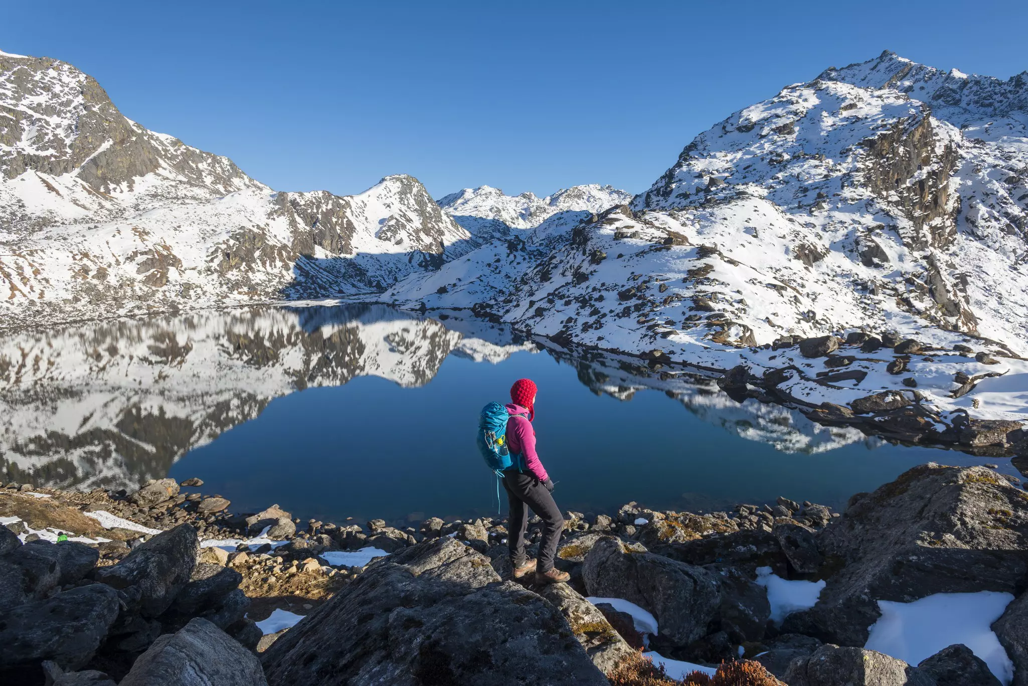 A woman looks out over the holy lake of Gosainkunda in the Langtang region of Nepal.