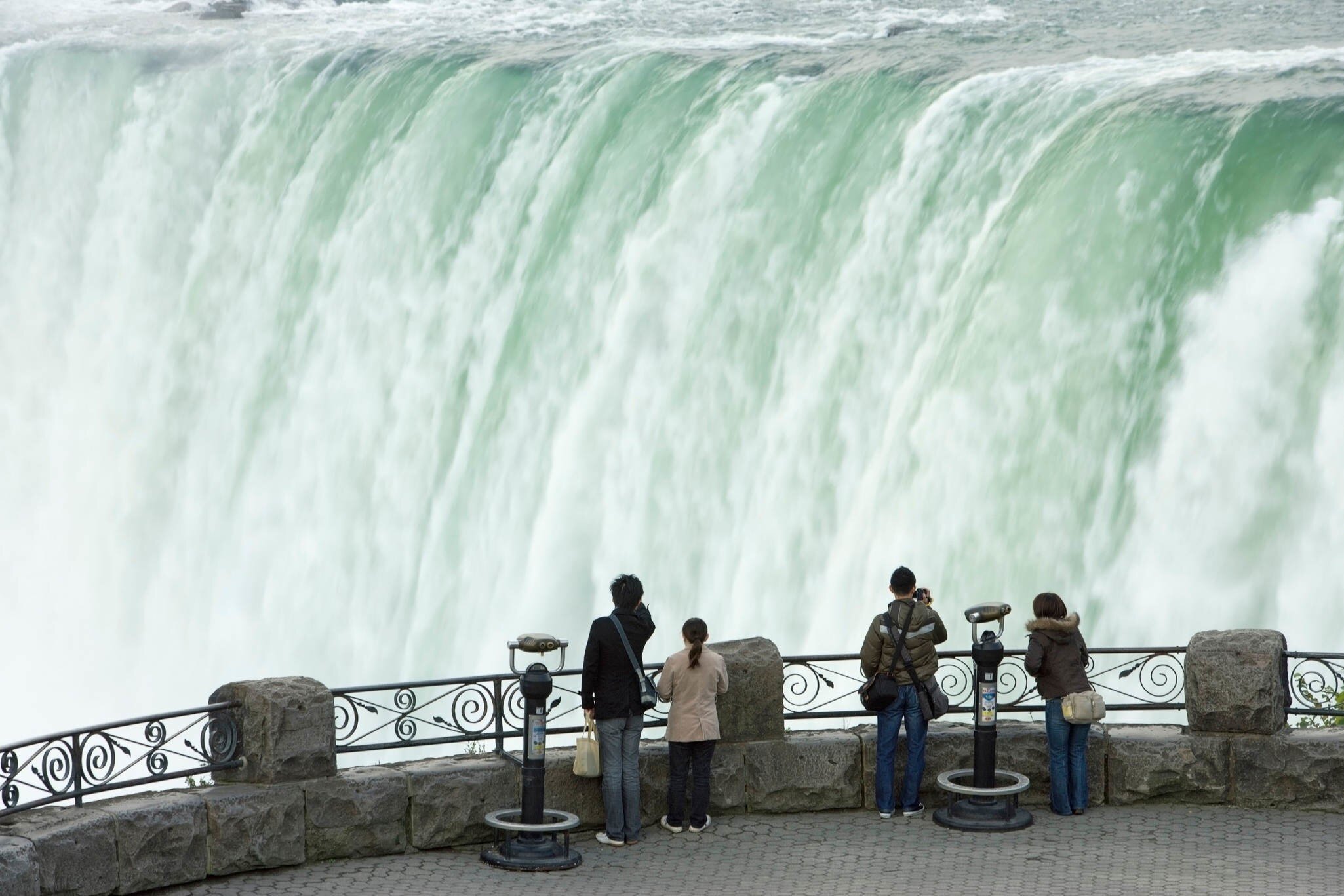People looking at Horseshoe Falls from Table Rock viewpoint in the Niagara Falls, Canada.