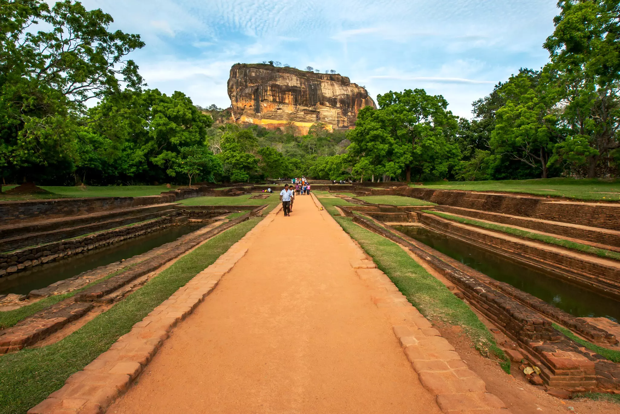 View of a large ancient rock fortress with ancient gardens in the foreground