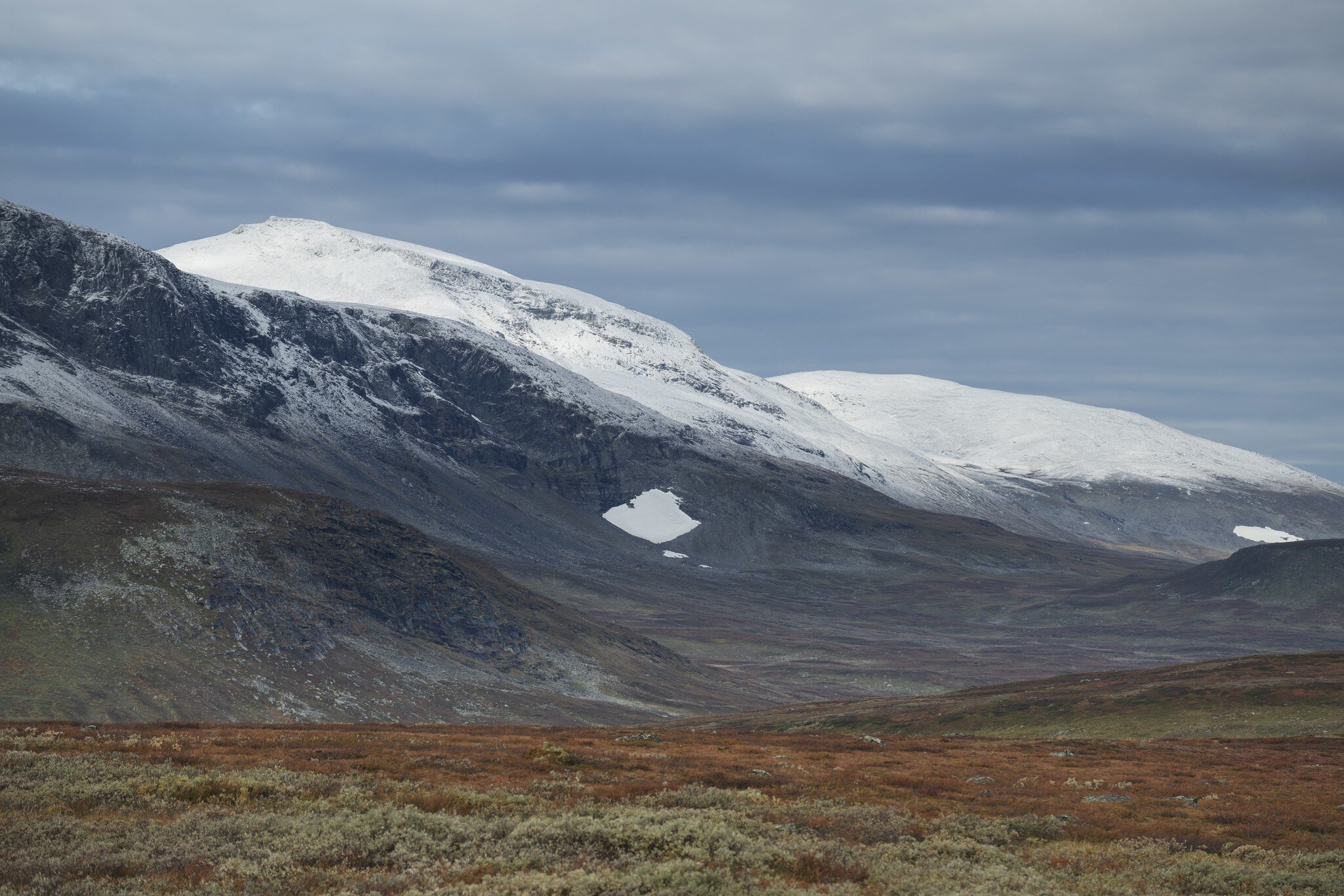 Dusting of autumn snow coveres Ammarfjället mountains in Vindelfjällen nature reserve from Kungsleden Trail, Lapland, Sweden in Ammarnäs, Västerbotten County, Sweden