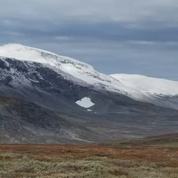 Dusting of autumn snow coveres Ammarfjället mountains in Vindelfjällen nature reserve from Kungsleden Trail, Lapland, Sweden in Ammarnäs, Västerbotten County, Sweden