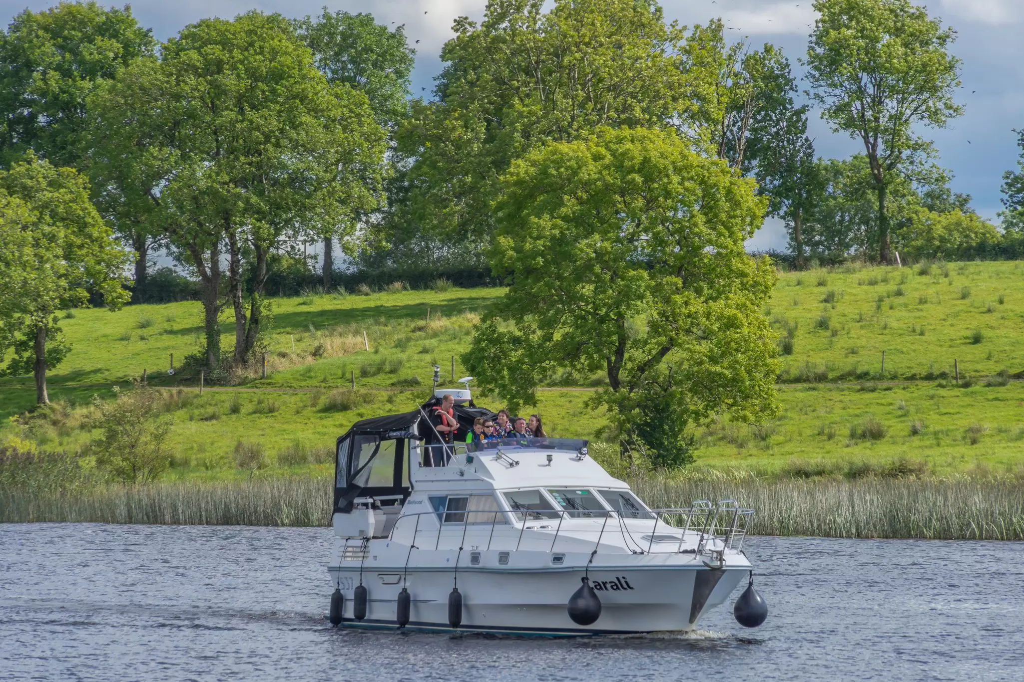Editorial use only; a small cruise boat on the river Shannon, at Carrick on Shannon, Co. Leitrim, Ireland, in August 2016., License Type: media, Download Time: 2025-12-04T16:42:27.000Z, User: nic.dhoedt_lonelyplanet, Editorial: true, purchase_order: 56530 - Guidebooks, job: Global Publishing WIP , client: Lonely Planet Ireland 17, other: Nicolas D'Hoedt