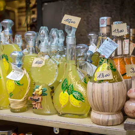 Bottles of limoncello and lemon related products in a souvenir shop