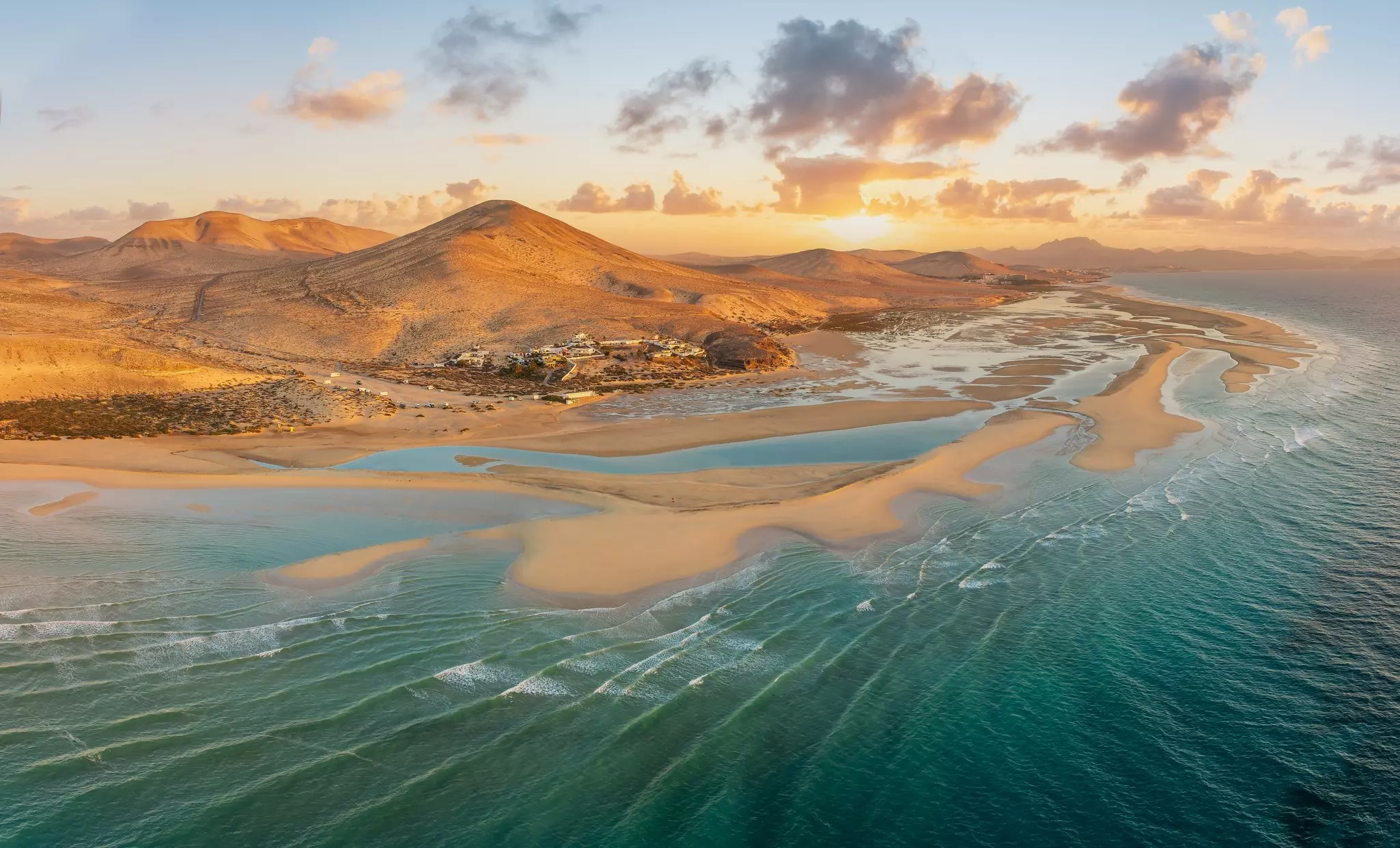 Playa de Sotavento at sunrise, Fuerteventura: a breathtaking aerial view of crystal-clear lagoons and sweeping sand dunes on this iconic Canary beach