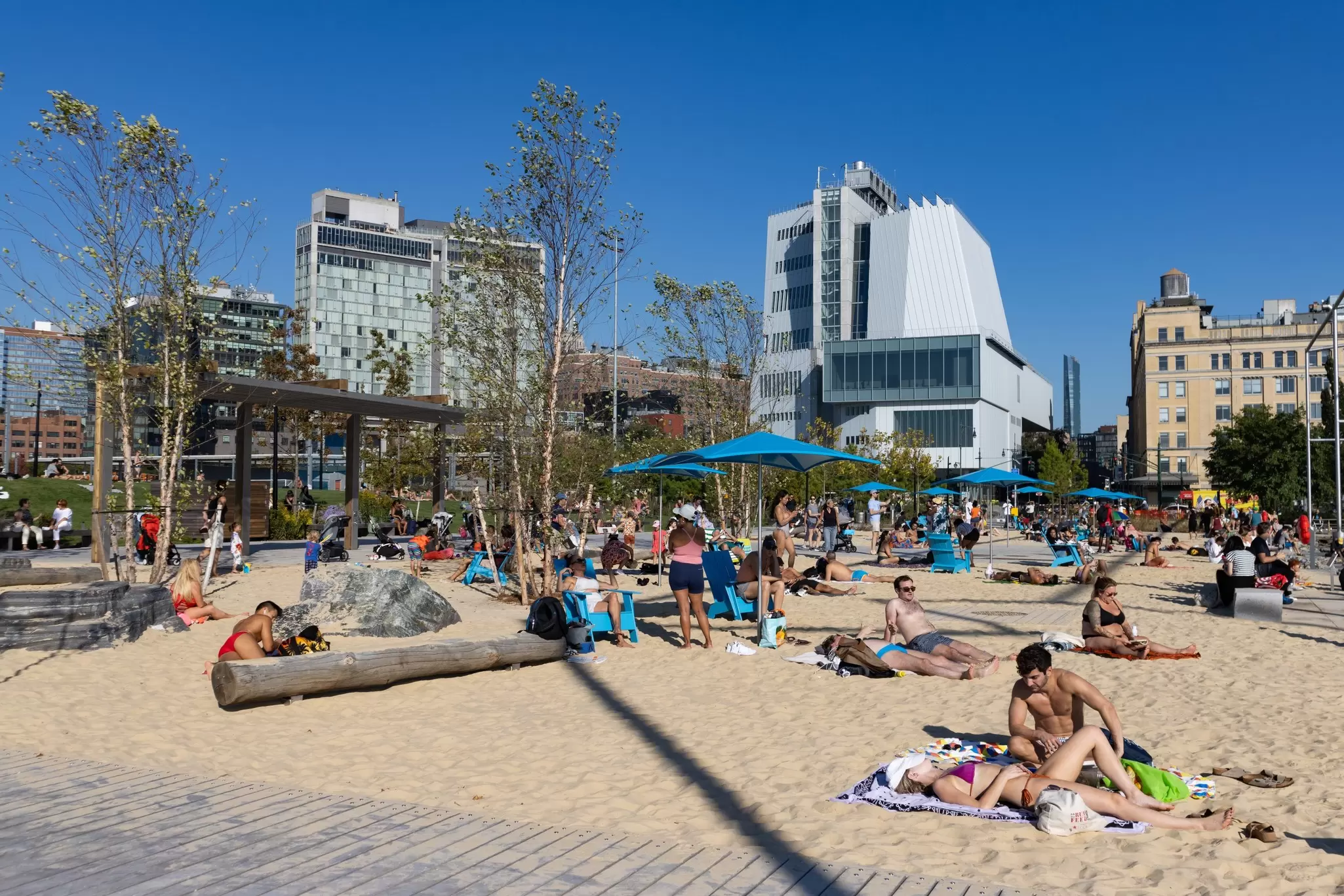 People tanning at the public Manhattan Beach on the Gansevoort Peninsula in New York City.