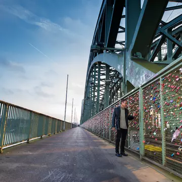 A tourist walking on the Hohenzollern Bridge and looking to the colorful love padlocks in Cologne (Koln), Germany
528287434
love, steel, symbol, friendship, city, germany, isolated, tourism, protection, padlock, colors, hohenzollern, relationships, girders, cologne, lock, perspective, place, make, key, train, footbridge, green, shape, wallpaper, texture, pedestrians, groups, many, declaration, people, names, iron, bridge, travel, fence