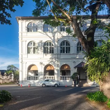 Trees frame the historic Amangalla hotel in the Fort area of Galle, Sri Lanka. 
