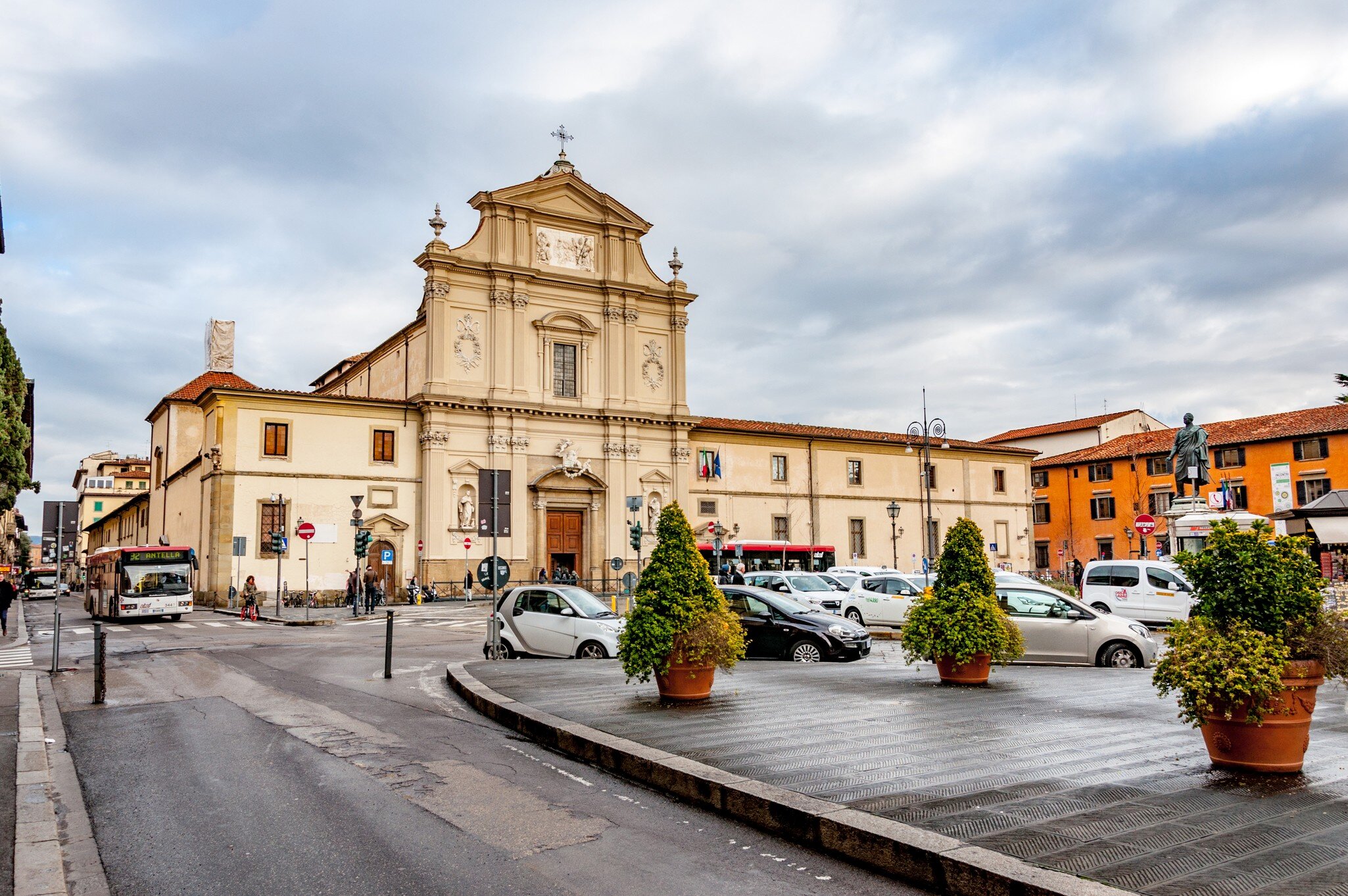 Cars in a tight parking area in front of a large building