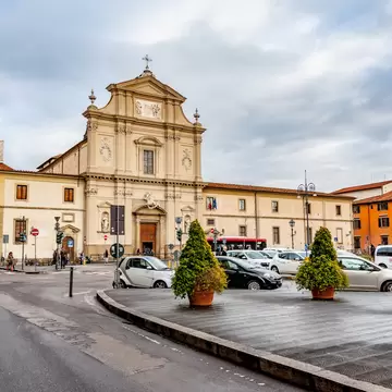 Cars in a tight parking area in front of a large building