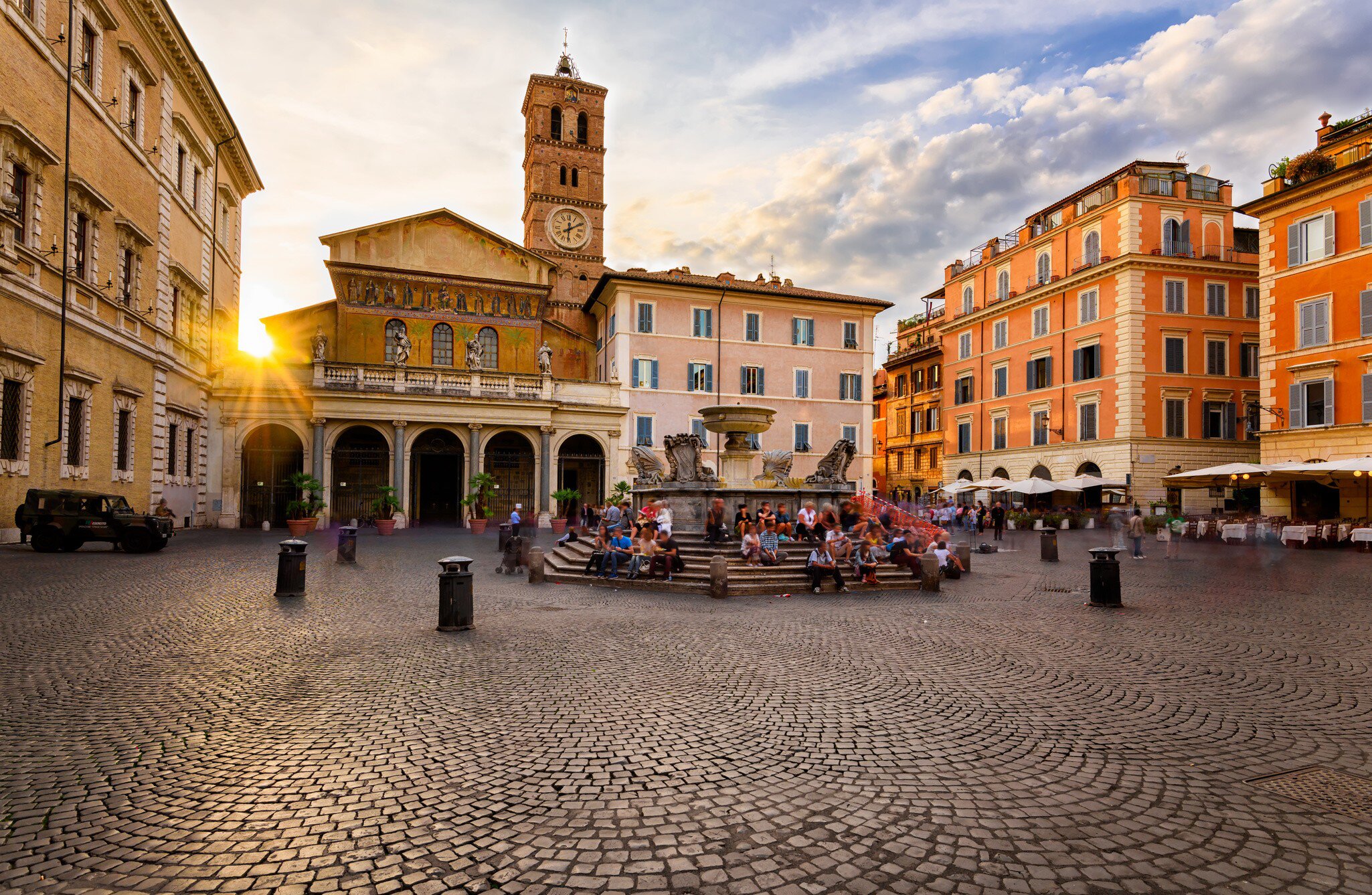 Basilica di Santa Maria and Piazza di Santa Maria in Trastevere during sunset.