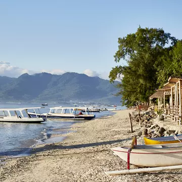 Beach huts and boats on Gili Air island, just off the coast of Lombok in Indonesia © John Laurie / Lonely Planet