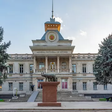 Neoclassical facade of the National History Museum of Moldova with the Capitoline Wolf statue in front