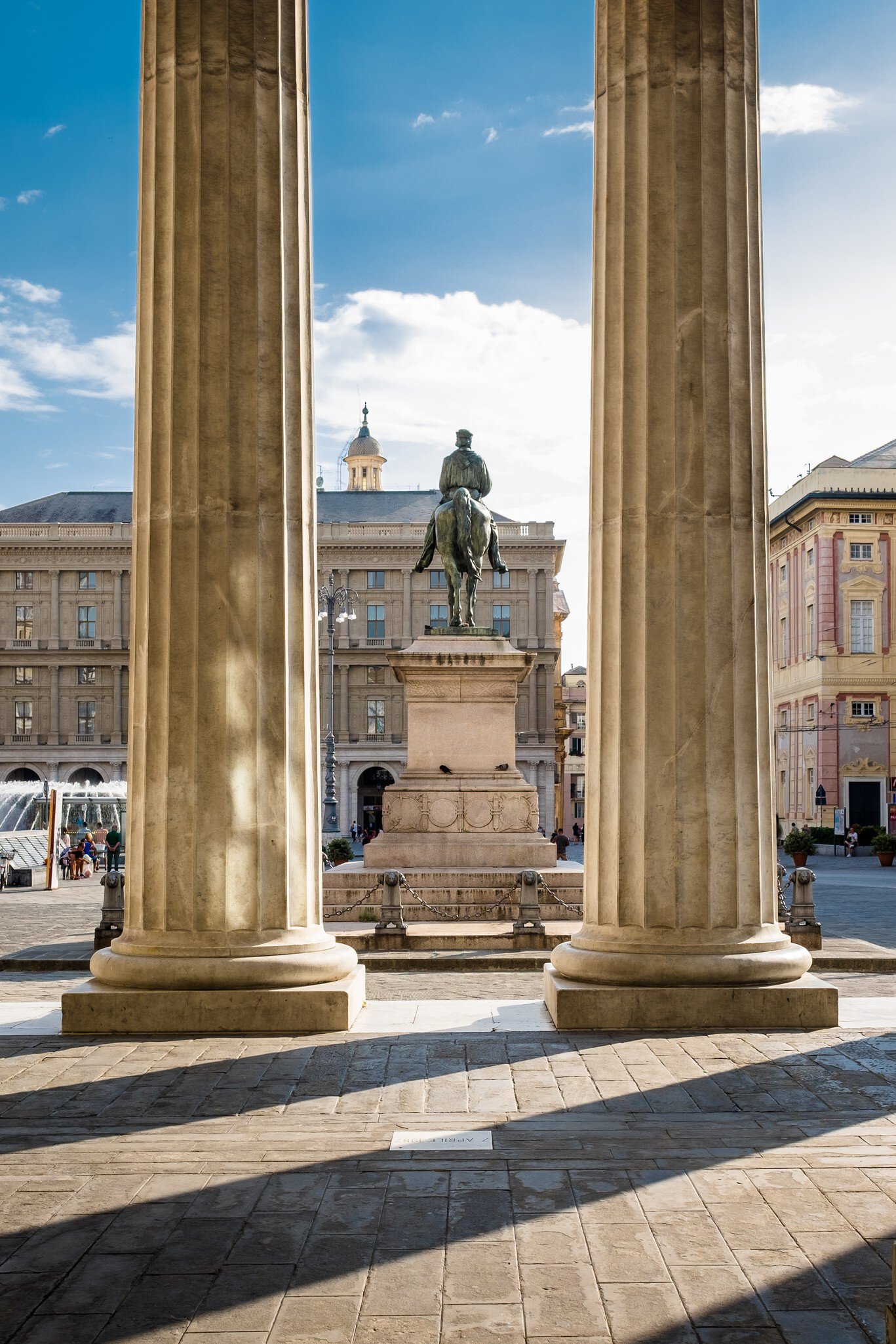 View of the Garibaldi Monument through the columns of Carlo Felice Theater.