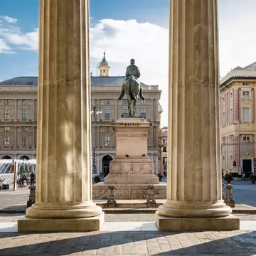View of the Garibaldi Monument through the columns of Carlo Felice Theater.