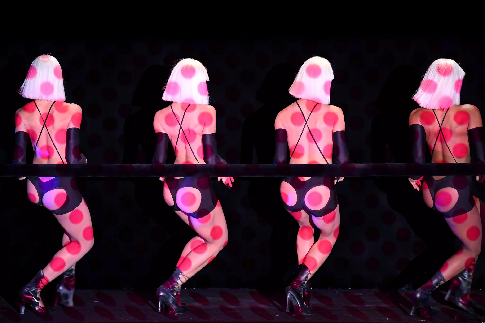 Dancers with polka dot lighting on the stage of the Crazy Horse cabaret