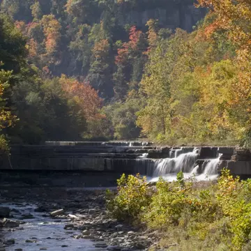 A small waterfall in central New York surrounded by trees in autumn.