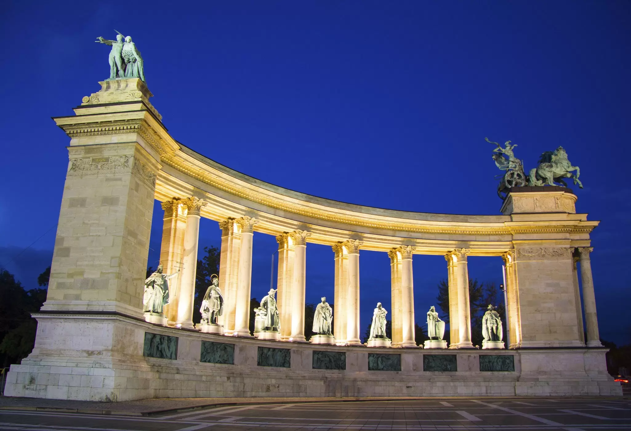 View of statues on Heroes' Square at night in Budapest, Hungary.